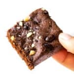 Hand holding espresso brownie square