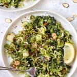 Top down view of shaved Brussels sprout salad on plate