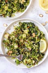 Top down view of shaved Brussels sprout salad on plate