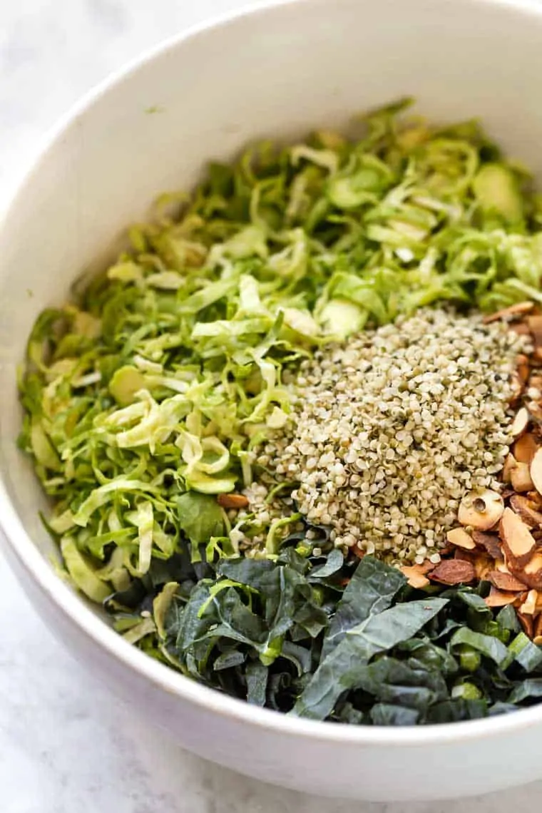 Ingredients for Shaved Brussels Sprout Salad in bowl before mixing