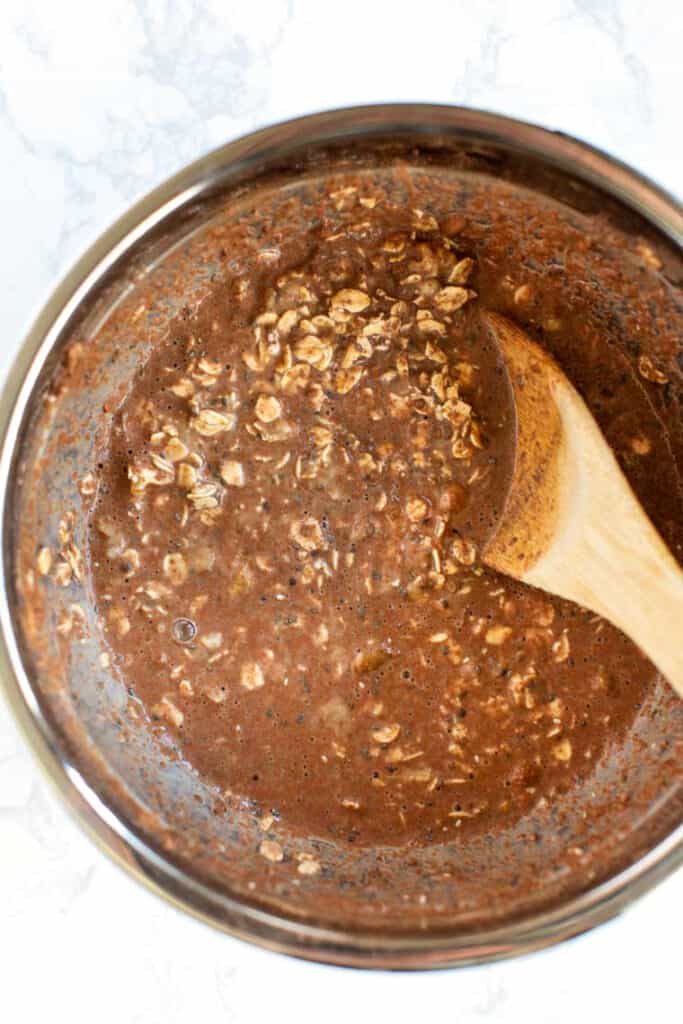Chocolate overnight oats are an easy breakfast that tastes like dessert! These chocolate oats are vegan, gluten-free, and great for meal prep. Chocolate oats in a mixing bowl.