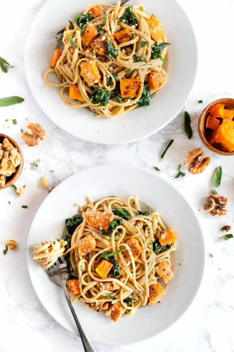 Two plates of Creamy Walnut Pasta with Butternut Squash