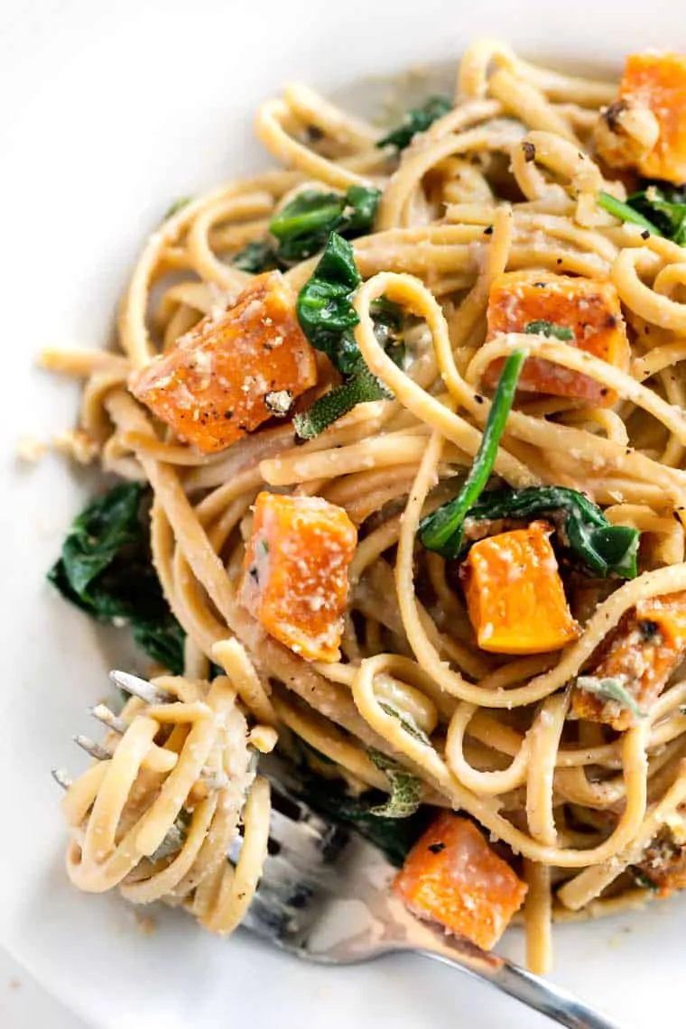 Butternut Squash & Spinach Pasta with walnut cream sauce on plate with fork