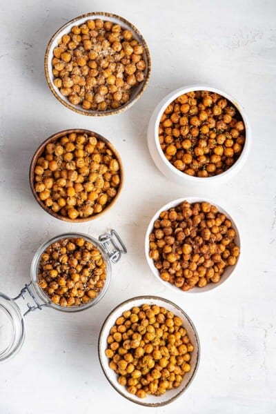 Overhead view of six jars filled with crispy chickpeas