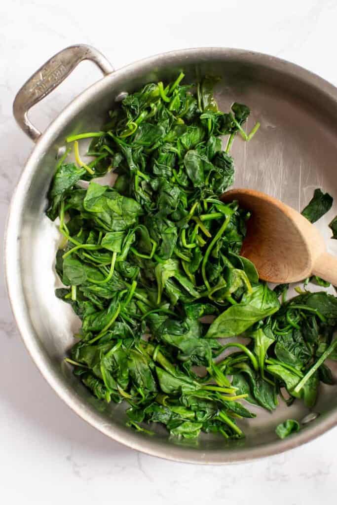 Wilting spinach in skillet.