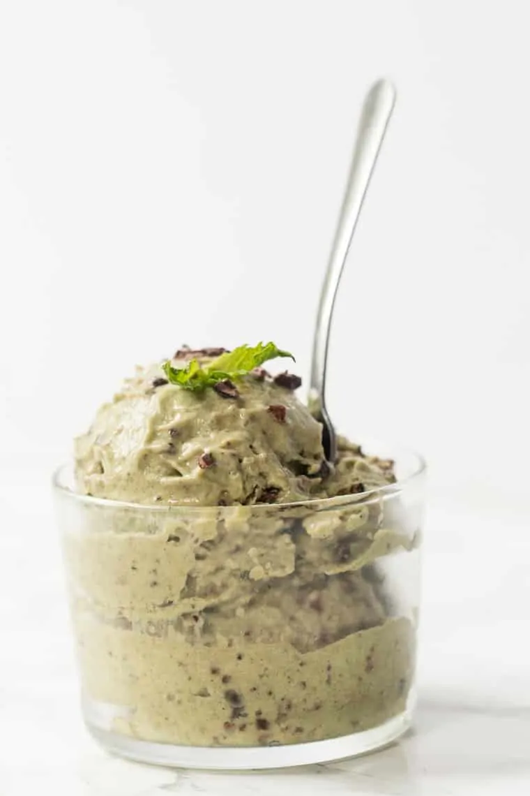 Mint chip banana ice cream in glass bowl with spoon