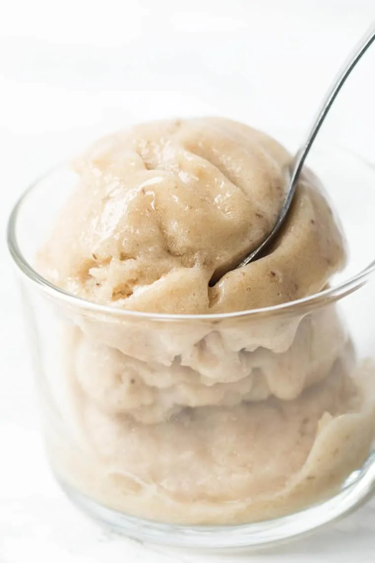 Vanilla banana ice cream in glass bowl with spoon