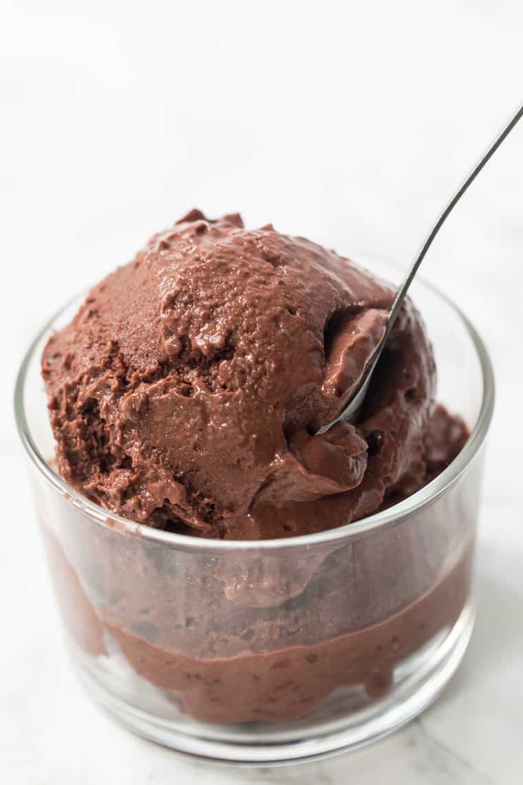 Chocolate cherry banana ice cream in glass bowl with spoon