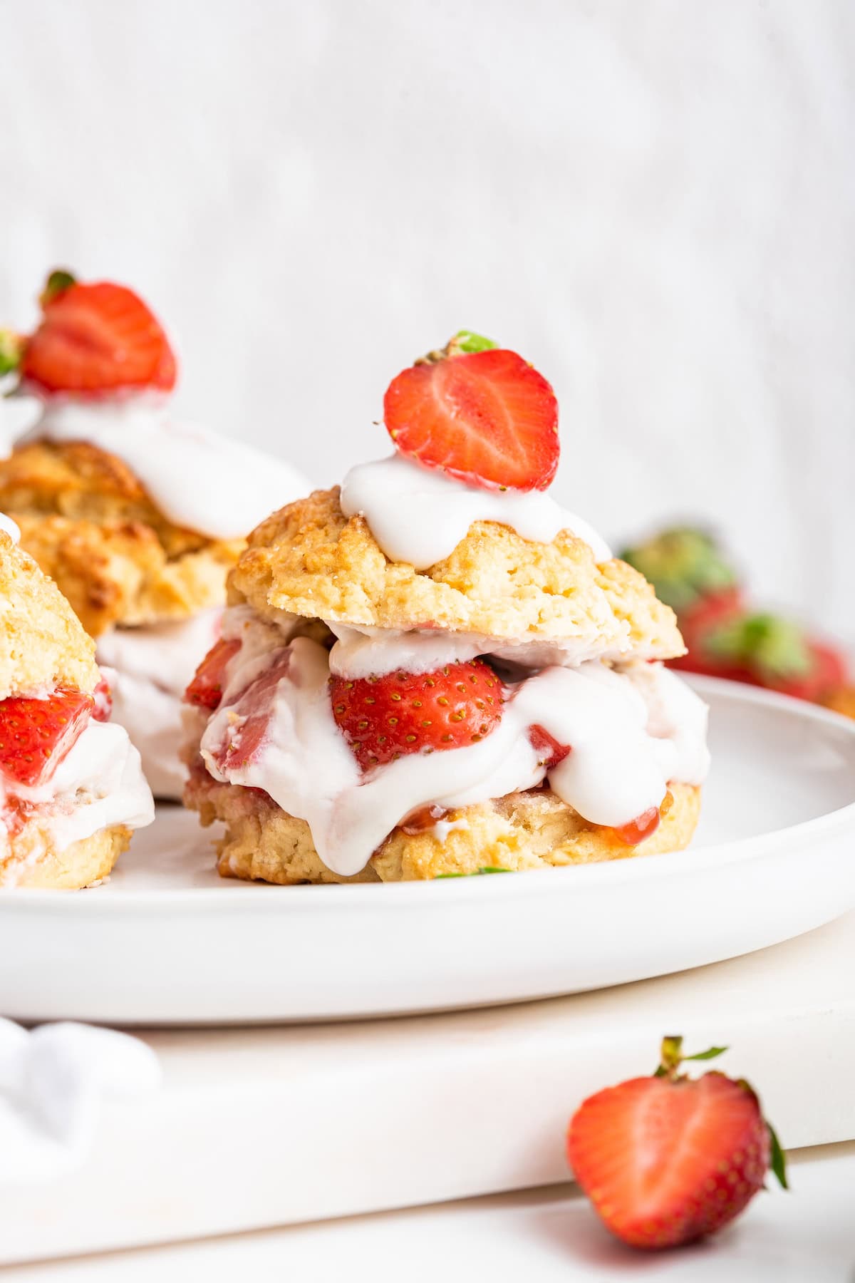 With fluffy homemade biscuits, coconut whipped cream and fresh strawberries, this vegan strawberry shortcake is the ultimate summer dessert! Closeup of vegan strawberry shortcake on plate