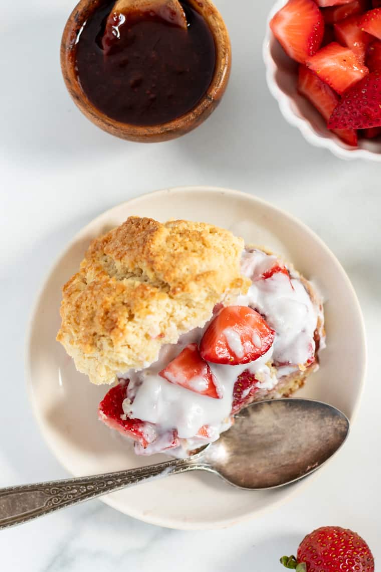 Overhead view of vegan strawberry shortcake on plate with spoon