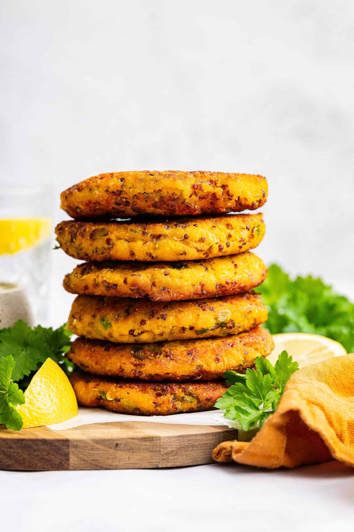 Stack of 6 salmon patties on wooden board