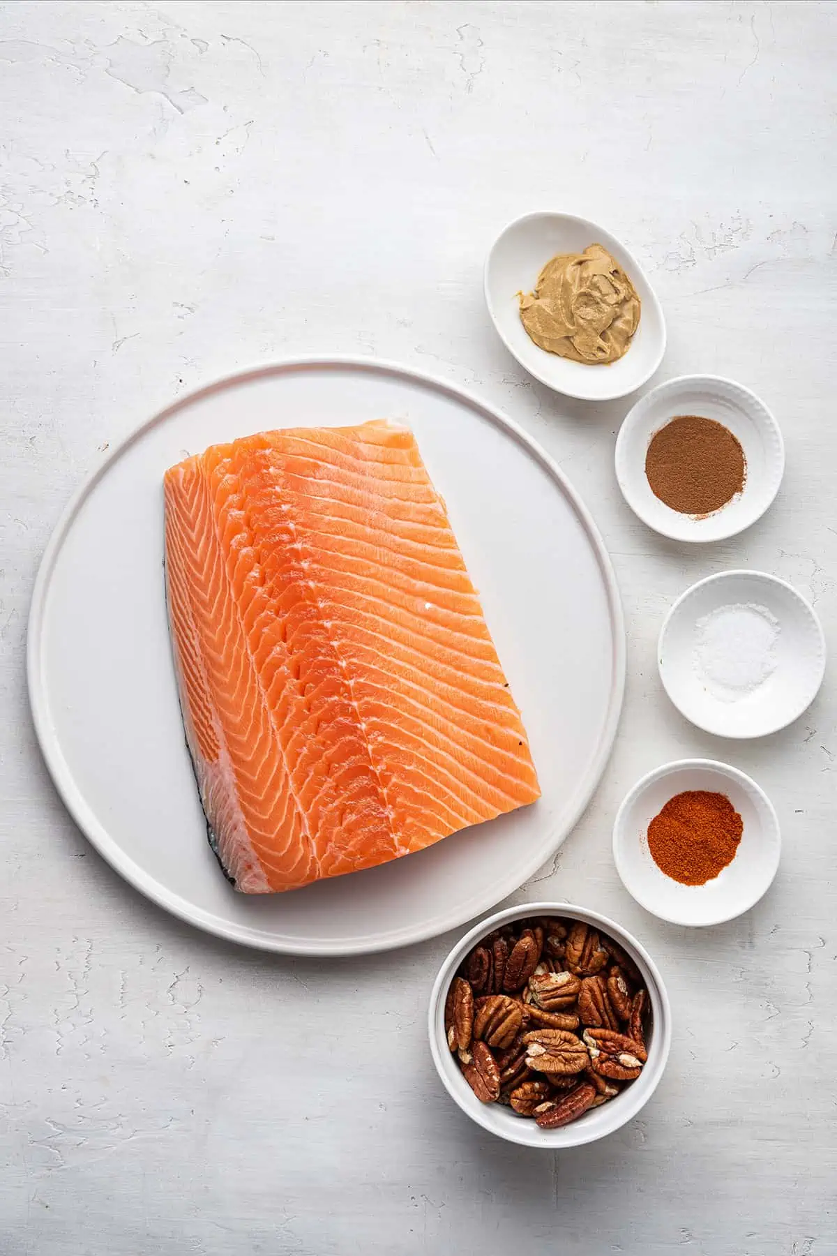 Ingredients for pecan crusted salmon in white bowls