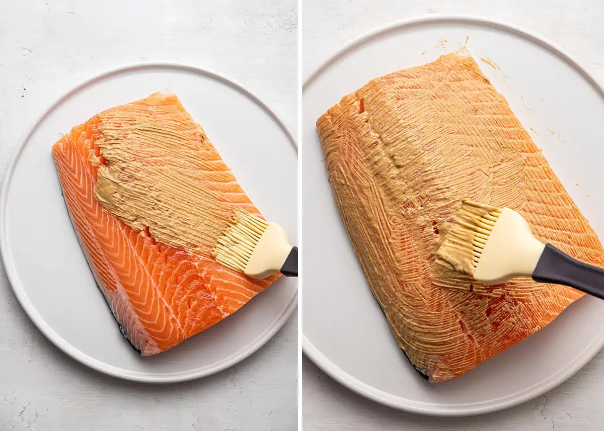 Side by side images of a large salmon filet being brushed with Dijon mustard.