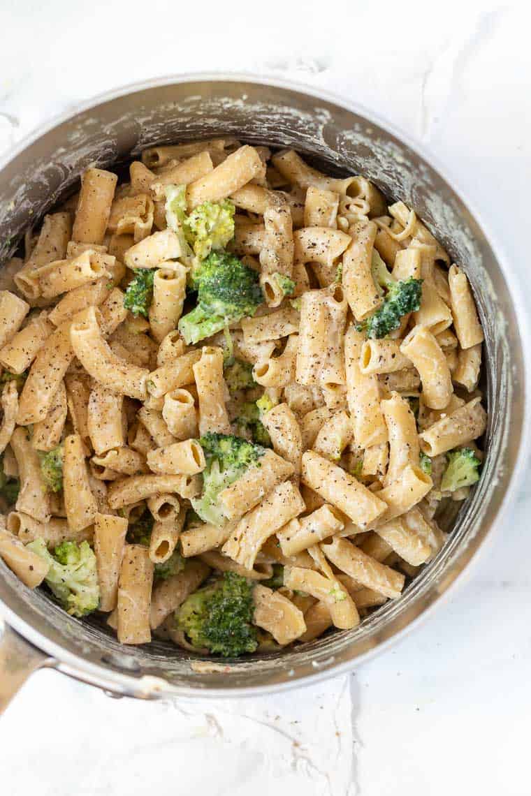 Make this creamy vegan lemon broccoli pasta in one pot with 6 ingredients! It's quick and easy, packed with cheesy flavor and tender veggies. Overhead view of creamy lemon broccoli pasta in a large pot.