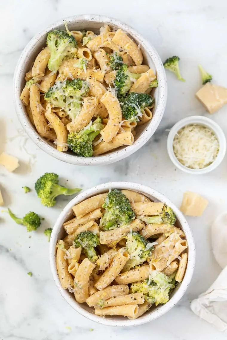 Make this creamy vegan lemon broccoli pasta in one pot with 6 ingredients! It's quick and easy, packed with cheesy flavor and tender veggies. Overhead view of two bowls of lemon broccoli pasta.