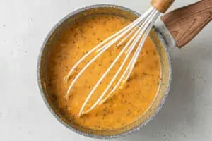 pot of pumpkin oatmeal with a whisk
