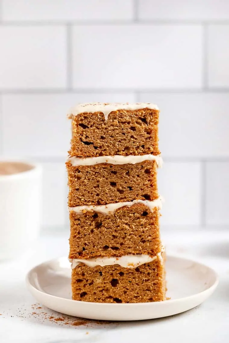A stack of four gluten-free apple cake slices on plate.
