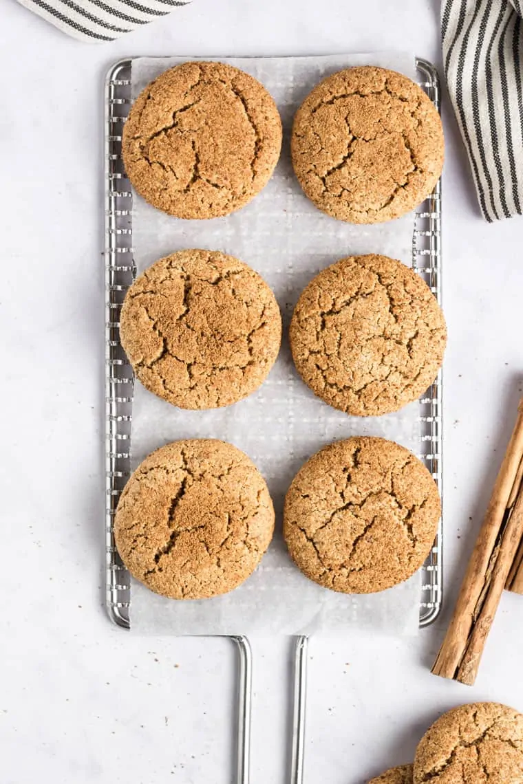 These vegan snickerdoodles use one bowl and 8 ingredients. This healthy snickerdoodle recipe is also gluten-free, grain-free, and paleo too! 6 Vegan Snickerdoodles on cooling rack