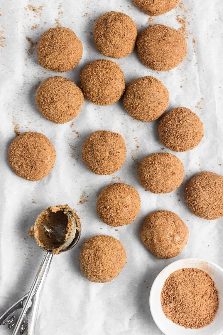 Balls of vegan snickerdoodle dough coated in cinnamon sugar