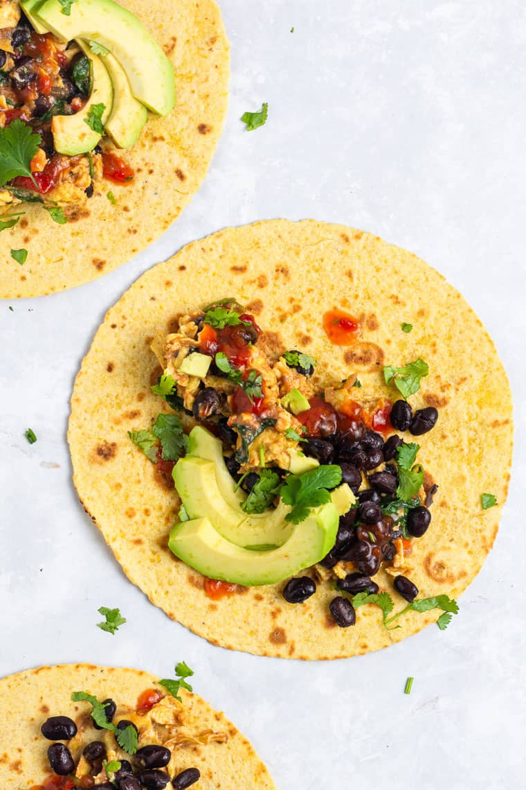 healthy breakfast tacos with eggs, beans and salsa