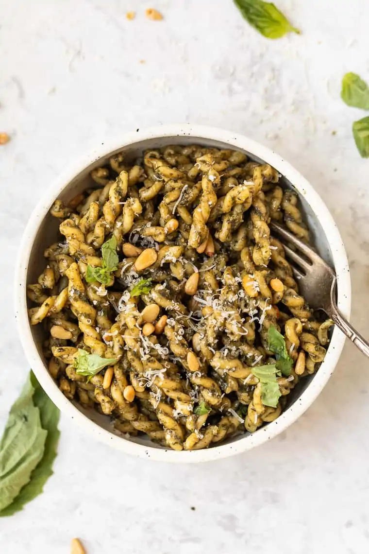 vegan pesto pasta with toasted pine nuts and vegan parmesan