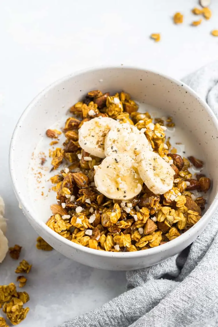 bowl of turmeric granola with sliced banana on top