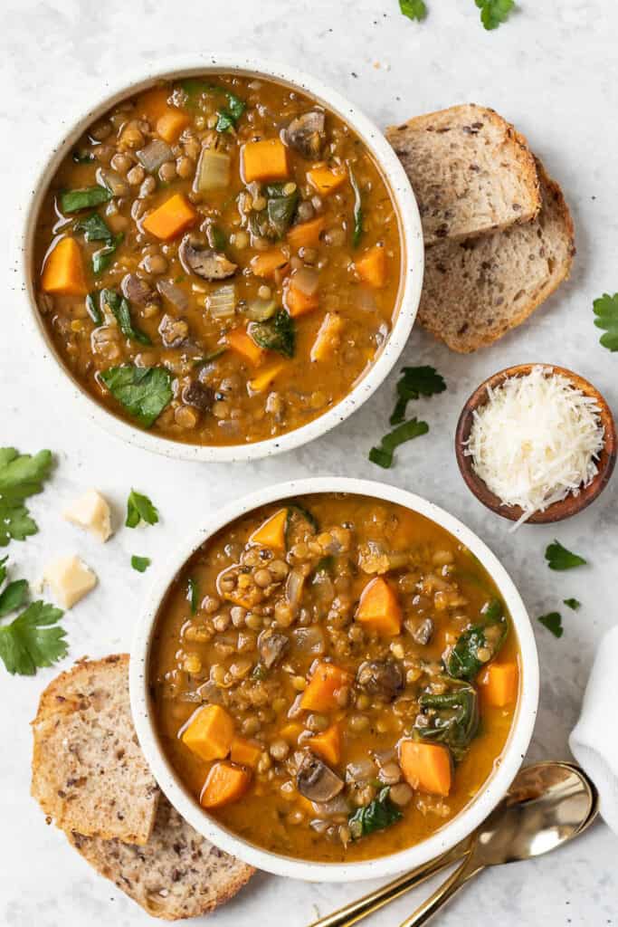 two bowls of sweet potato and lentil soup with toast