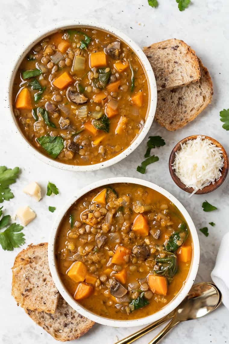 two bowls of sweet potato and lentil soup with toast