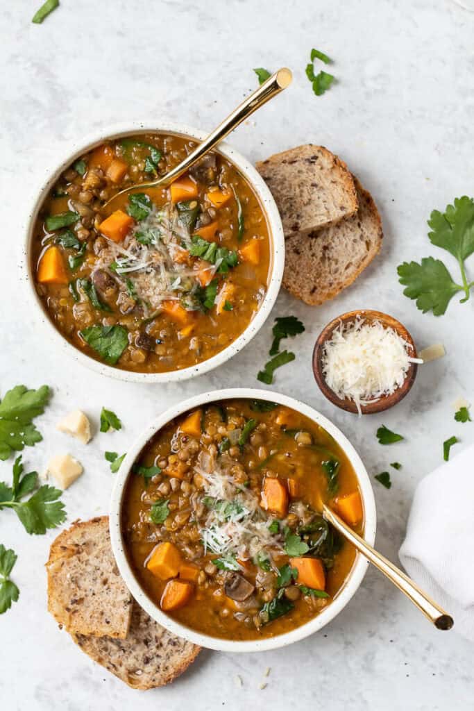 two bowls of vegetarian lentil soup with sweet potatoes