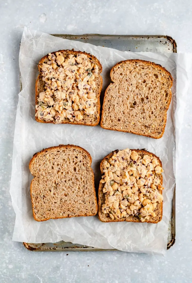 four pieces of bread for chickpea tuna melts with smashed chickpea salad on top