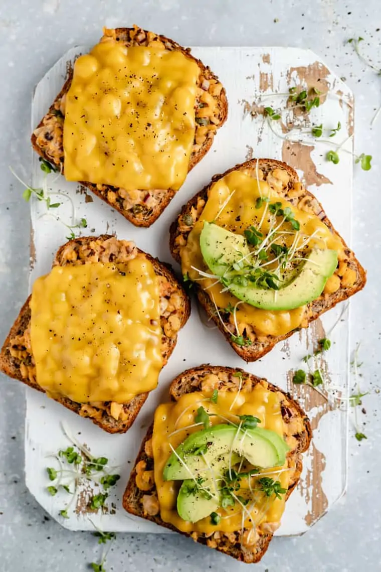 chickpea tuna melt recipe topped with avocado and mircogreens