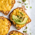 slice of chickpea tuna melt served with a slice of avocado