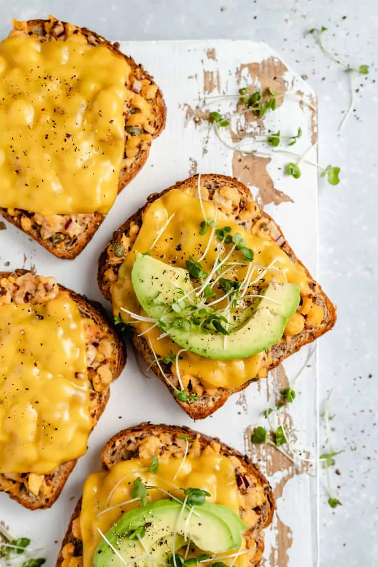 slice of chickpea tuna melt served with a slice of avocado 