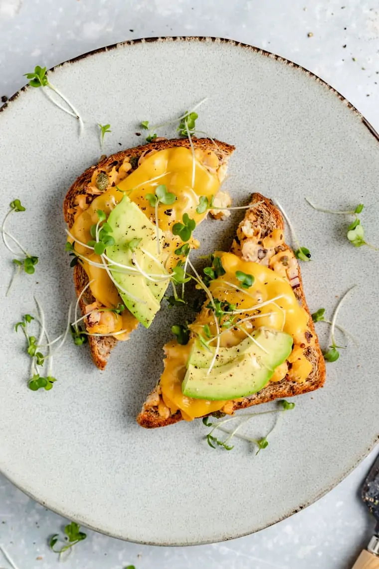 vegan tuna melt cut in half served with avocado and microgreens