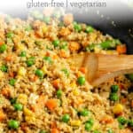 cooking quinoa fried rice with vegetables in a cast iron pan