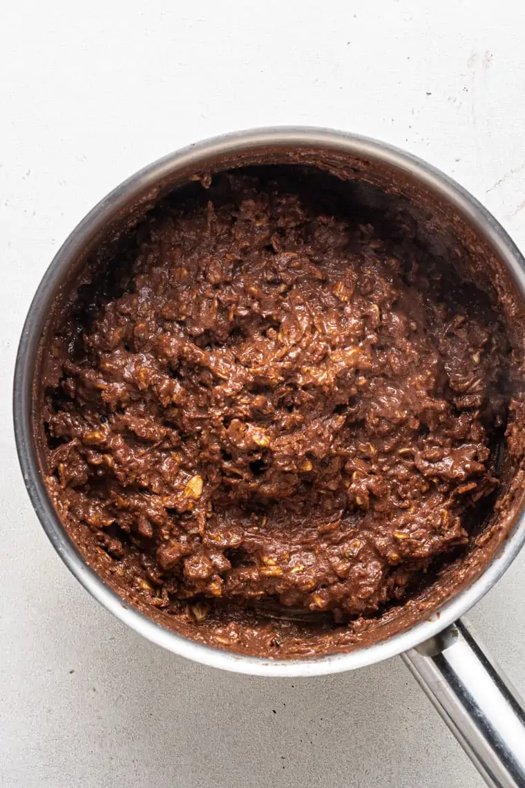 overhead of a silver pot with chocolate protein oatmeal