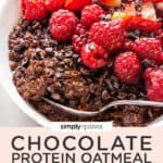 close up on a white bowl with chocolate protein oatmeal topped with fresh red berries