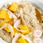 overhead of a bowl of creamy oats with mango and coconut chips on top