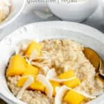 close up on a bowl of coconut steel cut oats with mango and coconut chips on top
