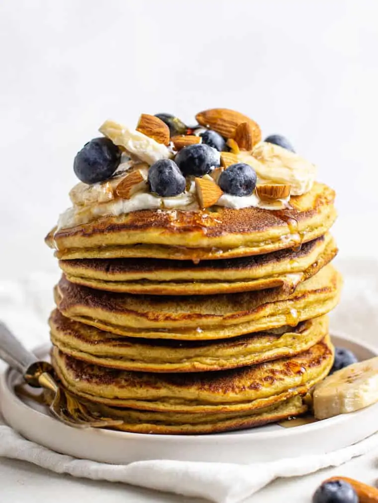 stack of protein pancakes with yogurt, berries and almonds