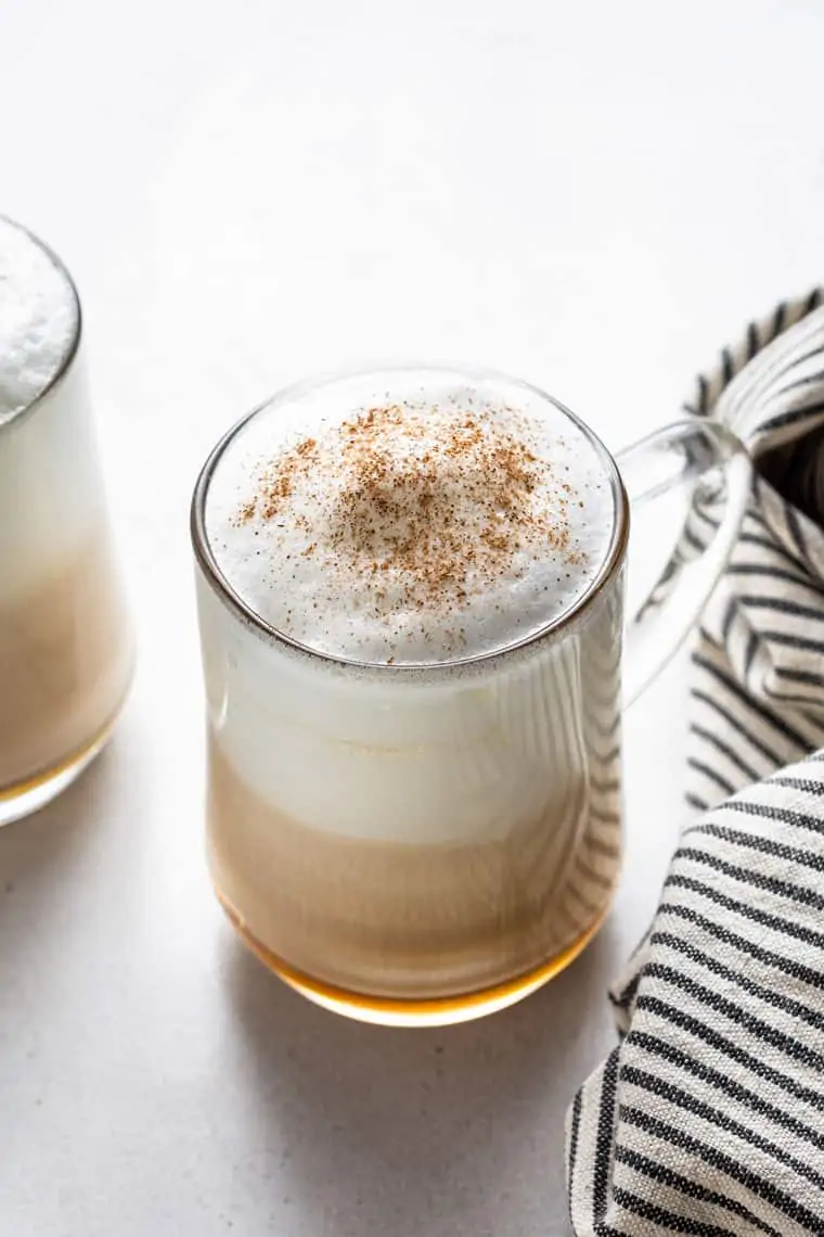 45 degree overhead of a glass mug with london fog latte topped with cinnamon