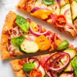 close up on slices of vegetable pizza with gluten free crust