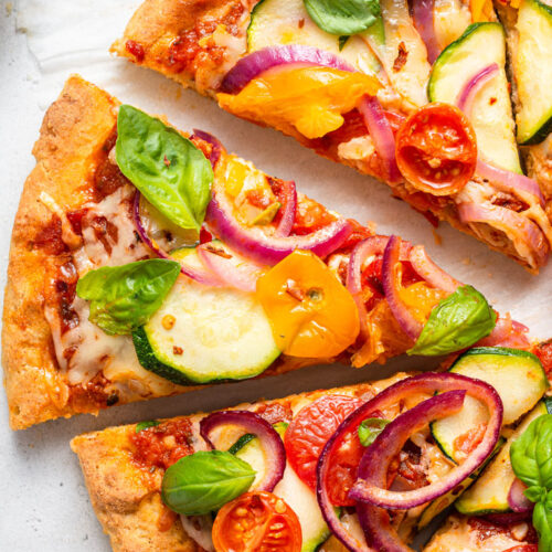 close up on slices of vegetable pizza with gluten free crust