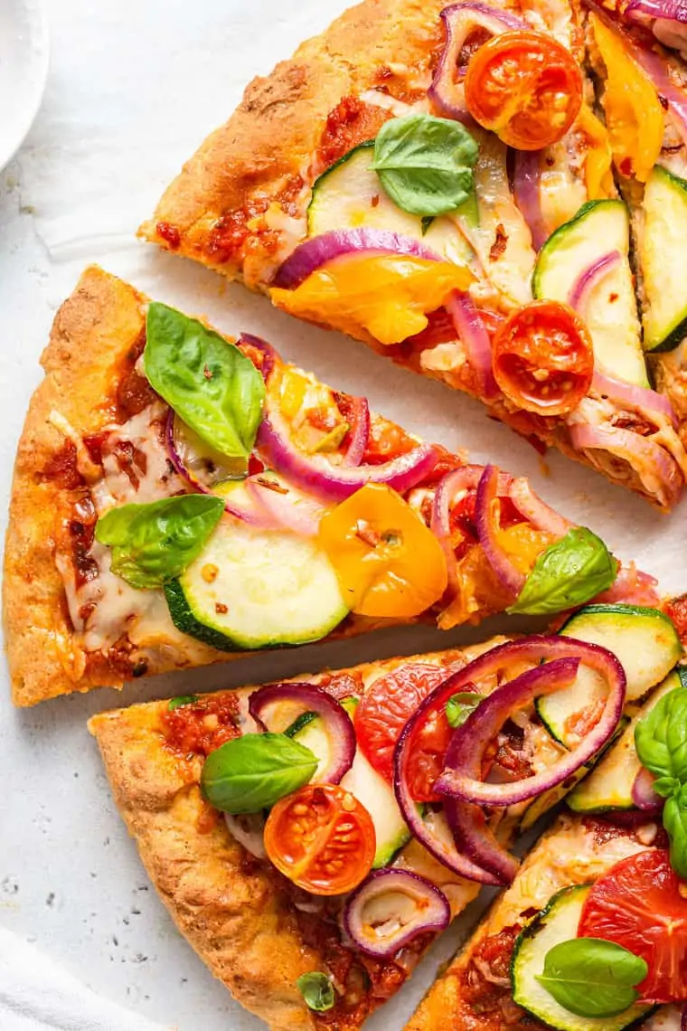 close up on slices of vegetable pizza with gluten free crust