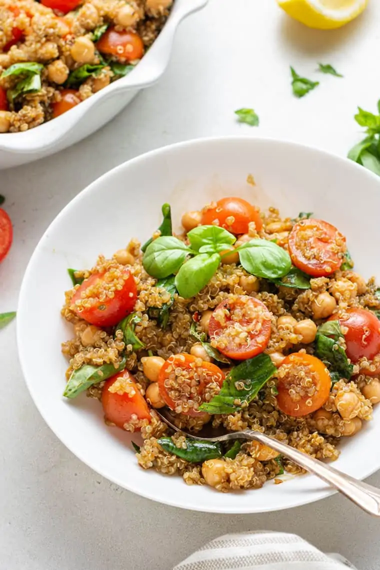 45 degree overhead of quinoa caprese salad with tomatoes and basil