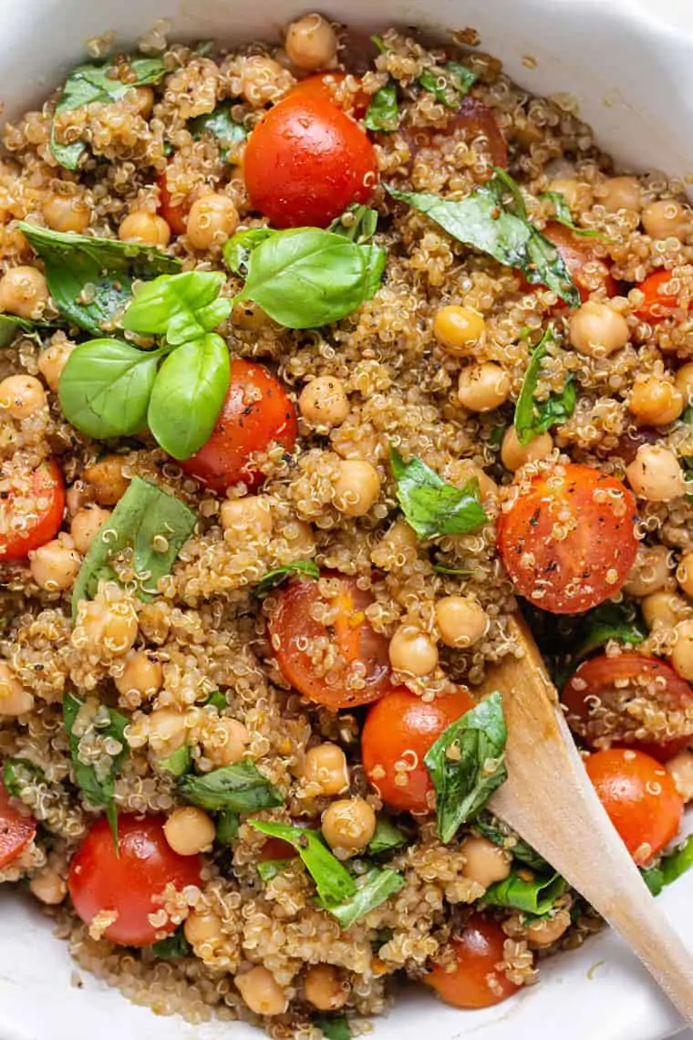 close up on detail of quiona salad with tomatoes, basil and balsamic dressing