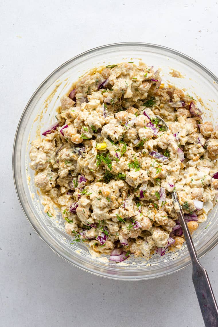 overhead of glass bowl with vegan smashed chickpea salad