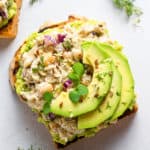 overhead of a slice of toast with smashed chickpea salad and avocado slices