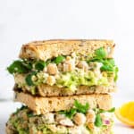side view of two chickpea caesar salad sandwiches on toast