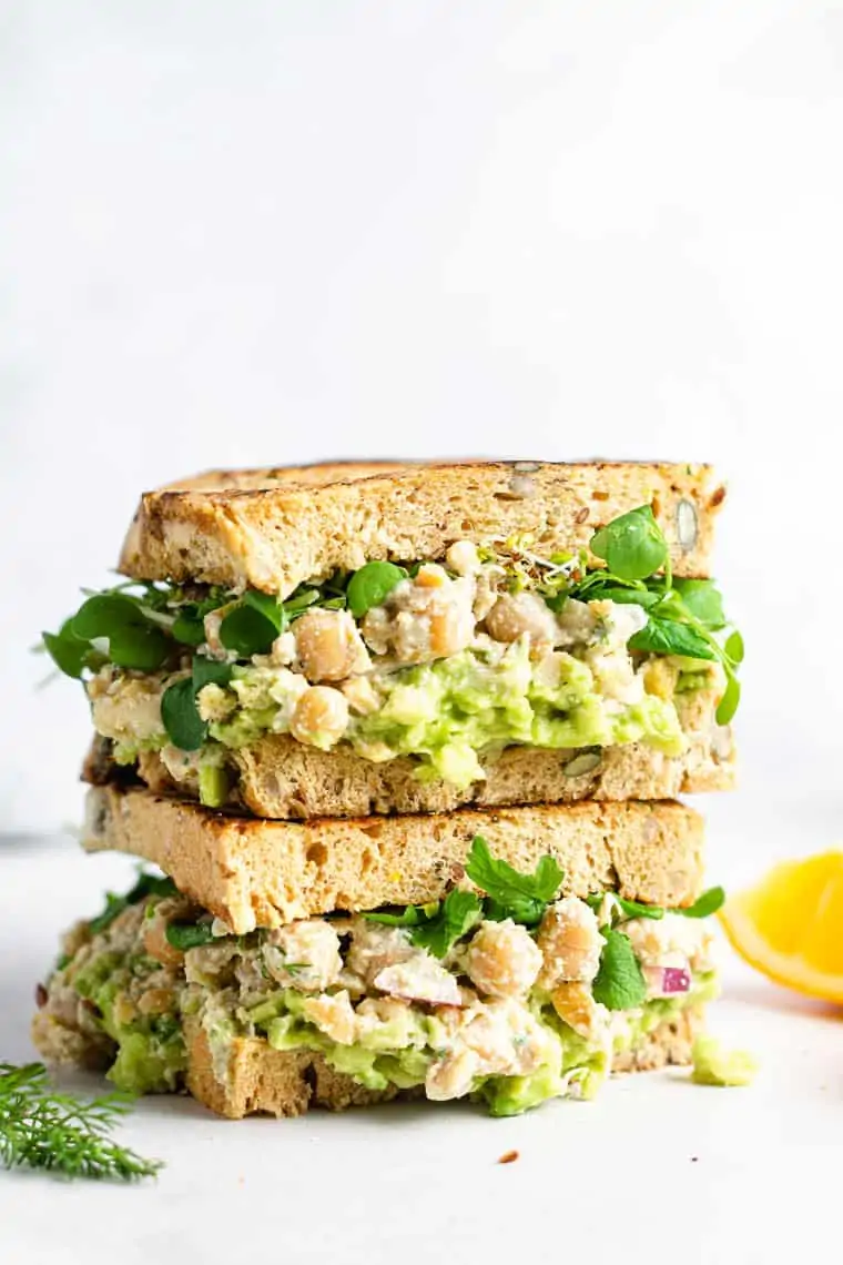 side view of two chickpea caesar salad sandwiches on toast